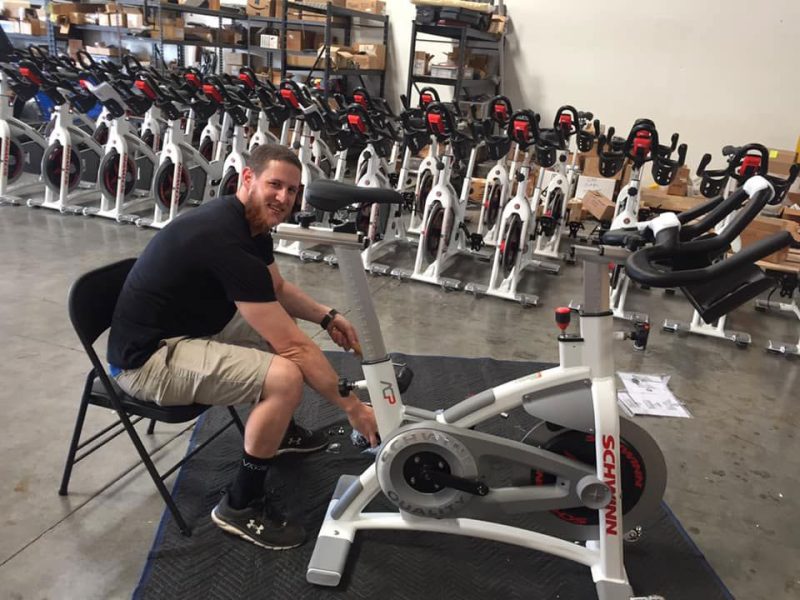 Image of a fitness technician assembling a indoor cycling bike